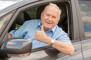 Old man driving a car